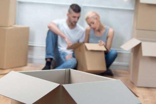 Furniture and boxes ready for transport by man and van in Ham