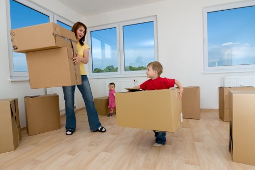 Professional movers loading household items into a van near Ham