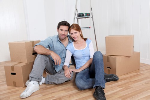 Boxes, wrapped furniture, and moving supplies prepared for a Ham removals service