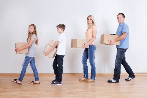 Professional movers handling boxes and furniture for a Ham relocation