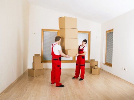 Low-carbon van being loaded with reusable furniture and packed boxes